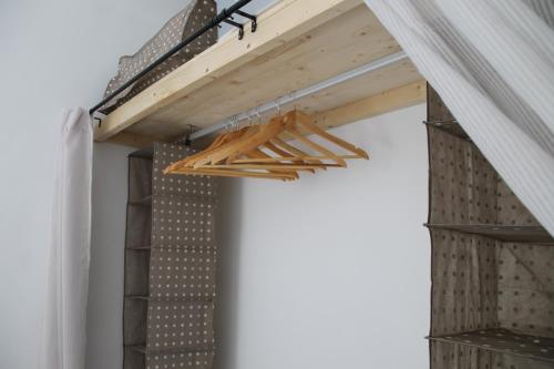 a bunch of wooden sticks hanging from a ceiling at Apoteka apartaments in Figueres