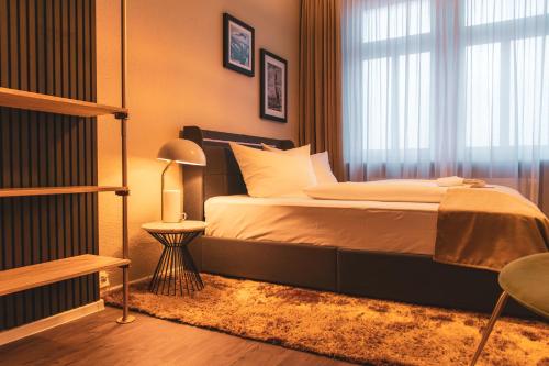 a bedroom with a large bed and a window at Cityloft Erfurt in Erfurt