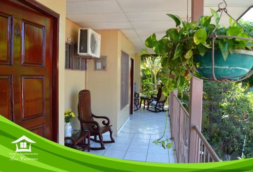 a porch of a house with a potted plant at Hotel y Apartments Los Cisneros in Managua