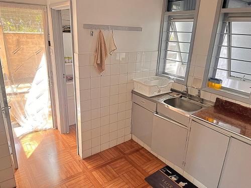 a small kitchen with a sink and a window at Luxury 4 BR Homely Apt with a pool in Kisumu