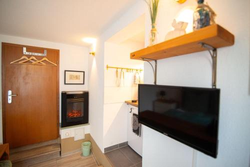 a living room with a tv and a fireplace at Appartement eleven in Duisburg