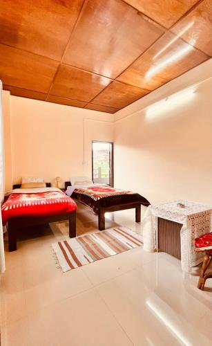 a living room with two benches and a wooden ceiling at Kusum Nest in Shillong