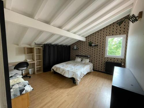 a bedroom with a bed and a window at Maison familiale in Bidart
