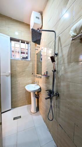 a bathroom with a sink and a shower at Esther & Hans Homes in Dodoma