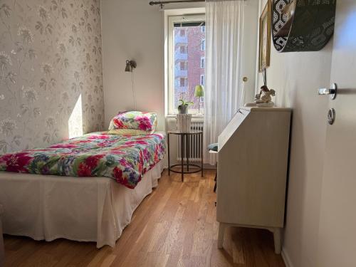 a bedroom with a bed and a window at Farsta Bed and Breakfast in Stockholm
