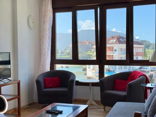 a living room with two chairs and a large window at Perez del Molino - 5806 in Isla