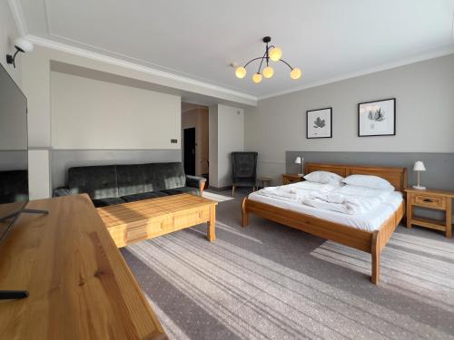 a large bedroom with a bed and a table at Willa 654 in Szklarska Poręba