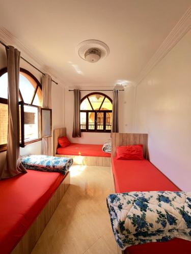 a room with two beds in a train at Tamraght Sunny apartment in Tamraght Ouzdar