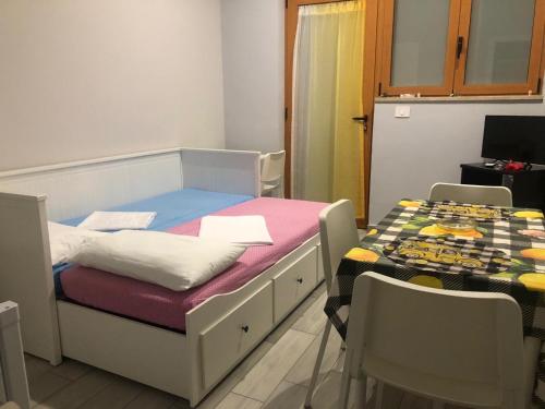 a room with a bed and a table and chairs at Sicily Sud-Est in Avola