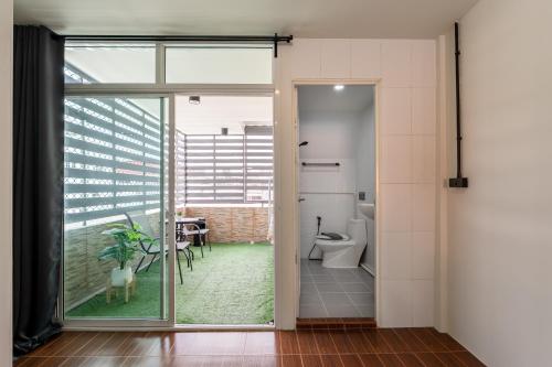 an open door to a bathroom with a toilet at Cool cozy In Yaowarat in Bangkok