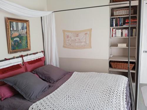 a bedroom with a bed and a book shelf at Le Jardin d'Anna in Saint-Eutrope-de-Born