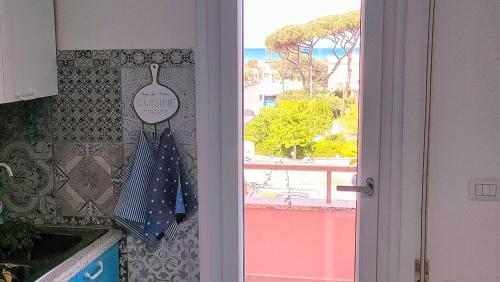 a kitchen door with an umbrella hanging on the wall at Anzio paradise in Anzio