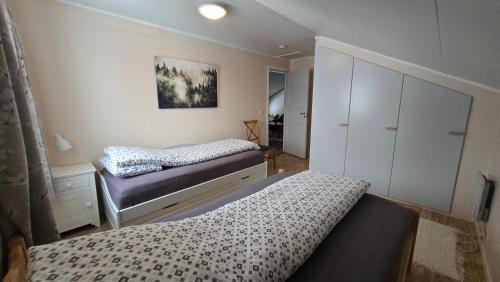 a bedroom with two beds and a dresser in it at Tromtind Lodge in Tromsø
