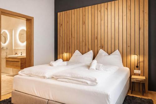 a bedroom with a white bed with towels on it at CHEZ NOUS - Balcony & Mountain View in Fügen