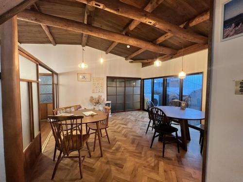 a kitchen and dining room with a table and chairs at Bike,Cafe and Inn 寄り道 in Iwagi-shima