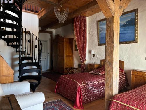 a bedroom with a bed and a staircase in a room at Kukšu muiža in Kukšas