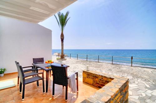 a dining room with a view of the ocean at Myrtos Mare Suites in Myrtos