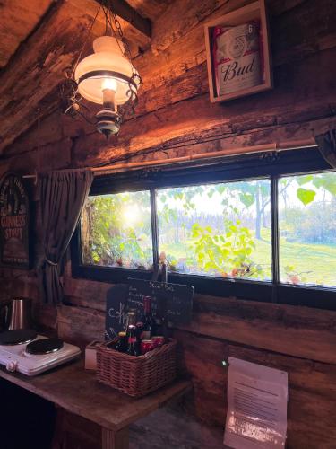 a room with a window in a wooden cabin at La Cabane Aux Loups in Crépy-en-Valois