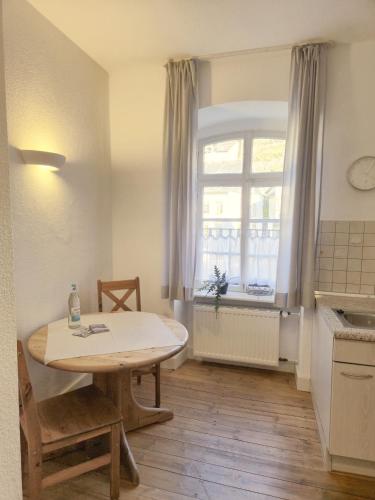 a small kitchen with a table and a window at Weingut Caspari, Familie Eggert in Traben-Trarbach
