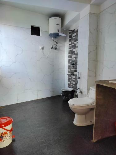 a bathroom with a white toilet in a room at Hotel Kabur in Pelling