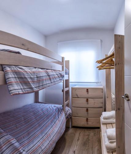 a bedroom with a bunk bed and a dresser at Ca La Josefa in Balaguer