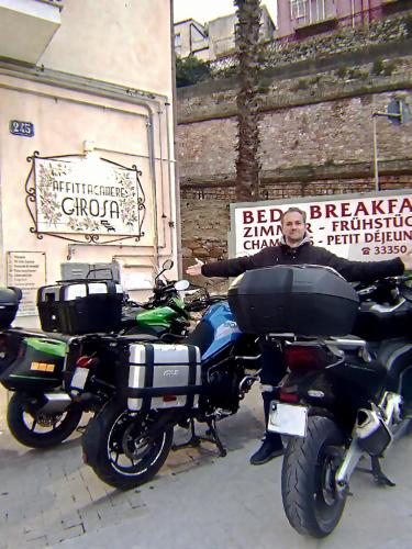 a man is standing next to two motorcycles at B&B Gi-Rosa Caltagirone in Caltagirone