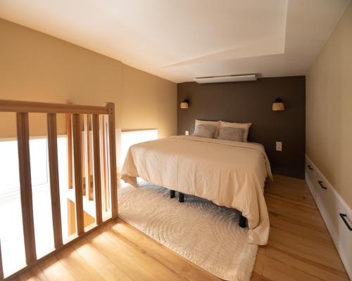a bedroom with a bed and a sliding glass door at La parenthèse lilloise in Lille