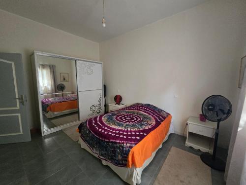 a bedroom with a bed and a large mirror at La Maison Ardiana in Oussouye