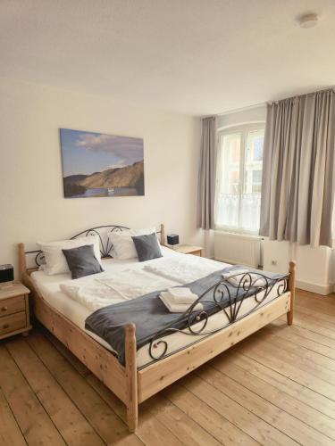 a bedroom with a large wooden bed in a room at Weingut Caspari, Familie Eggert in Traben-Trarbach
