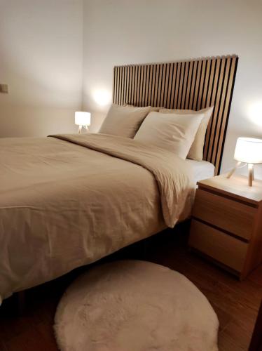 a bedroom with a large bed with two lamps at Ribeira Mar Guesthouse in Viana do Castelo