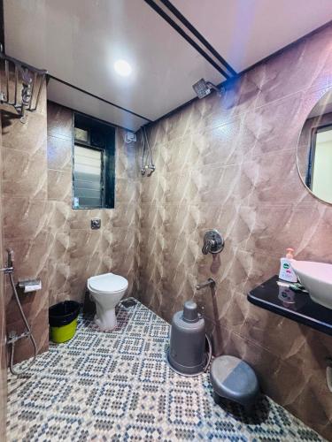 a bathroom with a sink and a toilet at Hotel Sunshine Airport in Mumbai