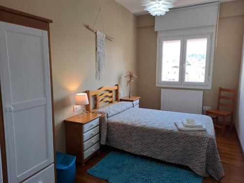 a bedroom with a bed and a window at Torre Plaza 4 in Boiro