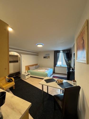 a room with a bed and a table in it at Hellwig Ferienwohnung 1 in Bernburg