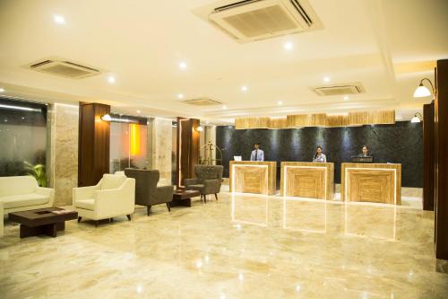 a lobby with two people standing at a podium at Sea Shell Coral Cove in Port Blair