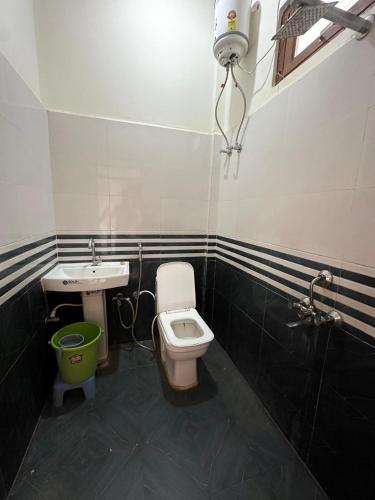 a bathroom with a toilet and a sink at Riskla hotel Near-Ram Mandir 700M in Ayodhya