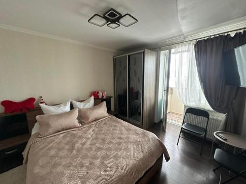 a bedroom with a bed and a ceiling fan at Apartment in Zolotonosha