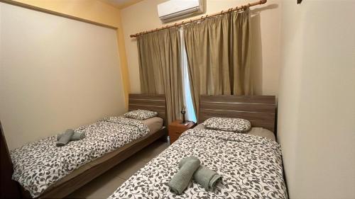 a bedroom with two beds and a window at Vergi Apartments in Pyla