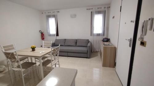 a living room with a table and a couch at Casa Cappuccini in Comacchio