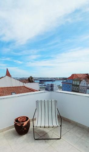 a bench sitting on the ledge of a roof at Figueira Penthouse by the Marina in Figueira da Foz