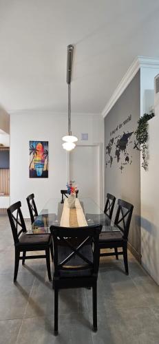a dining room with a glass table and chairs at Beach & House''Villa Maria'' 5 min to Mareta Beach in Sagres