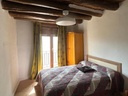 a bedroom with a bed in front of a window at Casa Jardin in Lobras