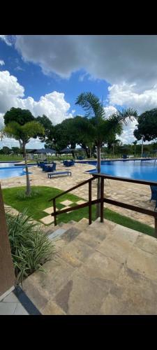 a wooden fence in front of a pool with trees at Day Use in Cascavel
