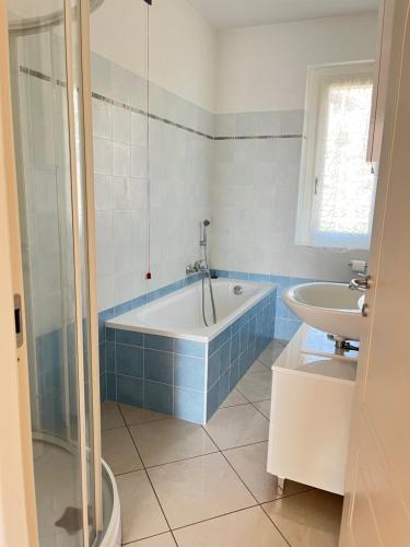 a bathroom with a tub and a sink at Casa Ilaria in Armeno