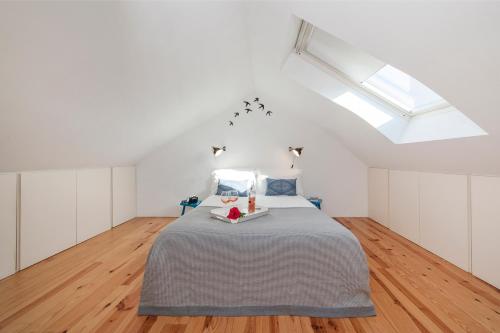 a bedroom with a bed and a skylight at Belem Apartment with Terrace in Lisbon