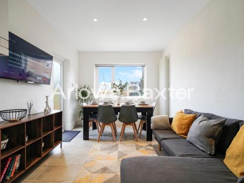 a living room with a couch and a table at Watford Large 5BR Home - Contractors & Families in Watford