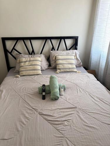 a bed with two towels and a bottle on it at Urban Oasis Symphony Pool in Cebu City