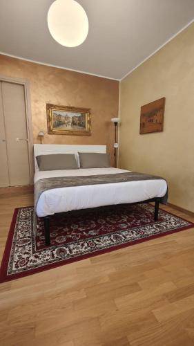 a bedroom with a large bed with a rug at Casa Vacanze Cesarina - Catanzaro centro in Catanzaro
