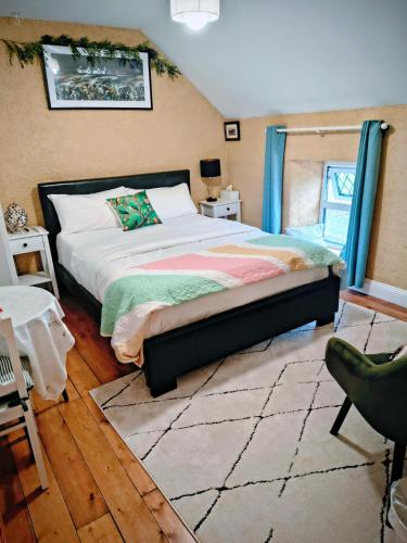 a bedroom with a large bed and a chair at Comfy Bedroom and Private Bathroom on the Top Floor of a Home Stay -10 mins walk to the center - Off street parking in Cork