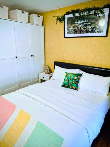 a bedroom with a white bed with a pillow on it at Comfy Bedroom and Private Bathroom on the Top Floor of a Home Stay -10 mins walk to the center - Off street parking in Cork