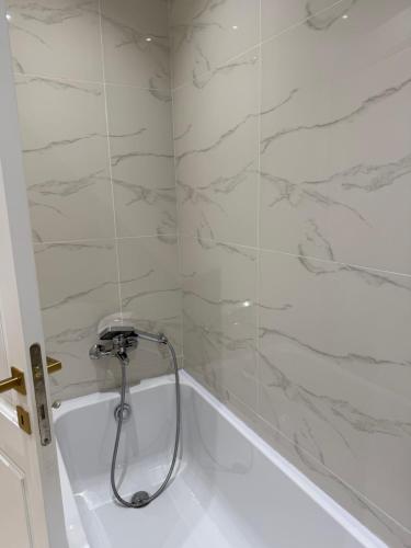 a shower in a bathroom with a tub at Perlina Naxxar in Naxxar